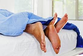 men and women in bed
