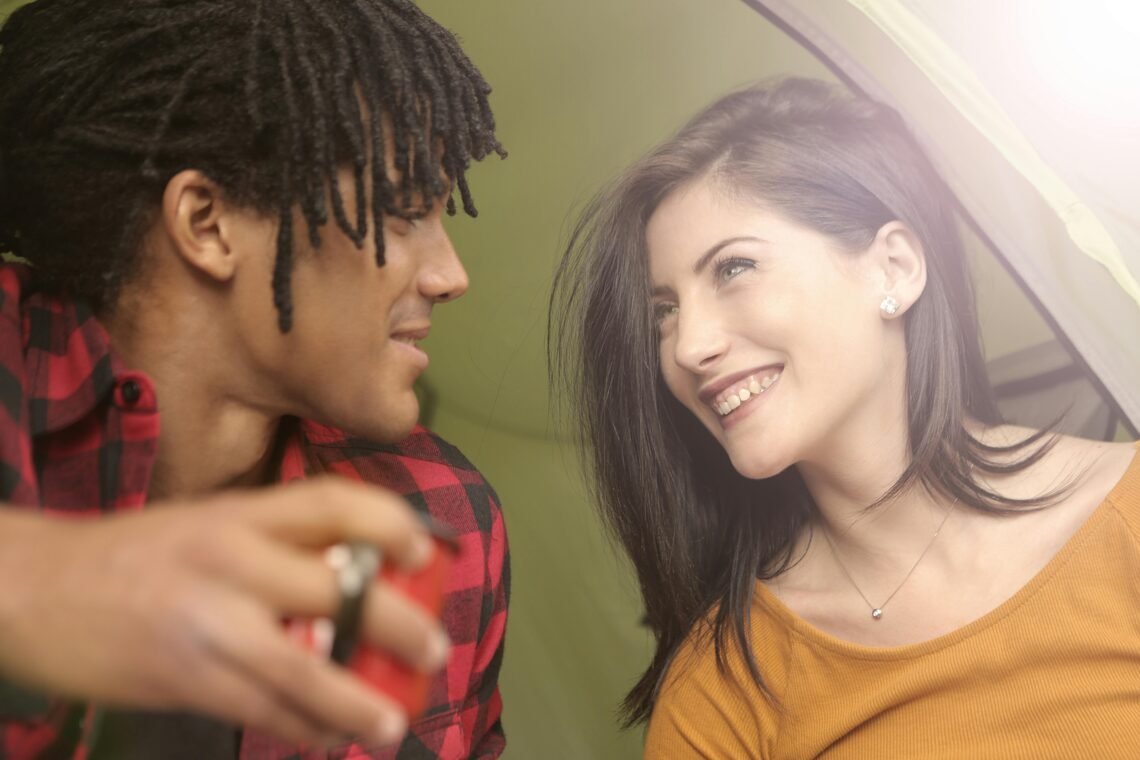 Cheerful multiracial couple looking at each other