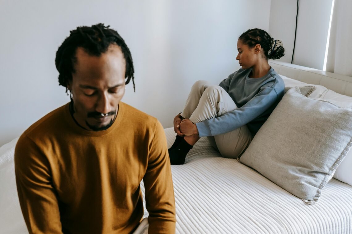 African American couple resting in bedroom