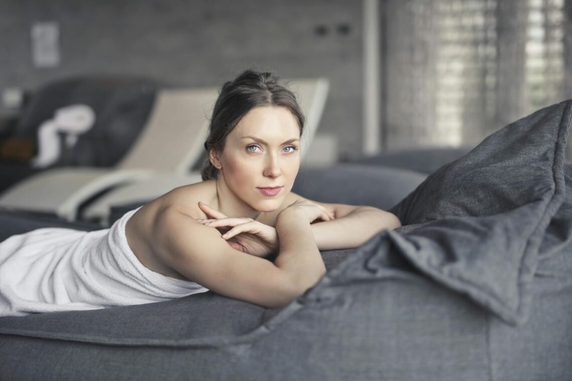Woman Covered in Towel Lying on Bed