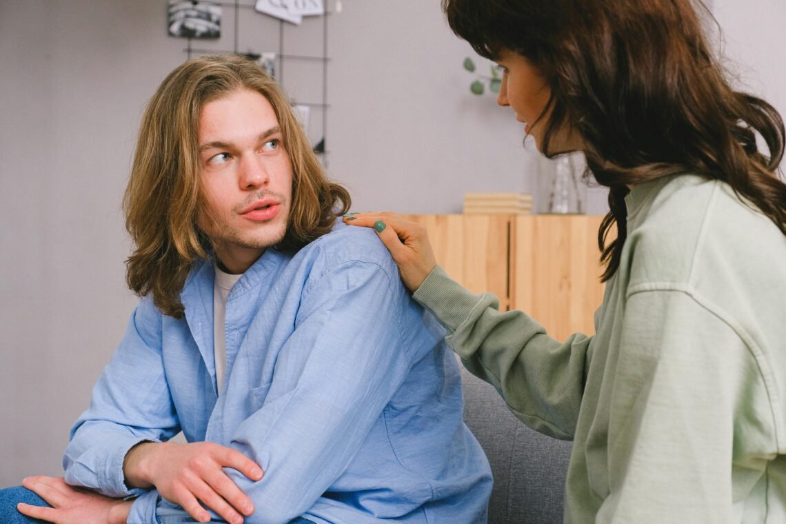 Woman talking with male in light room